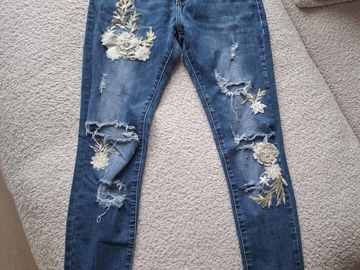 Parduoda: Plėšyti siaurėjantys džinsai su aplikacijomis
